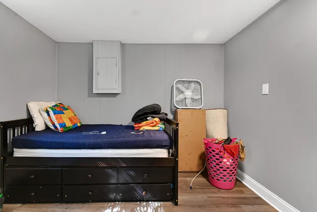 a living room with furniture and a dresser