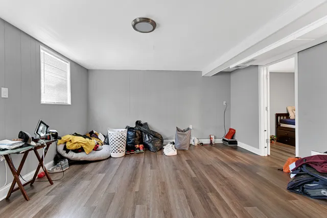 a bedroom with furniture and a wooden floor
