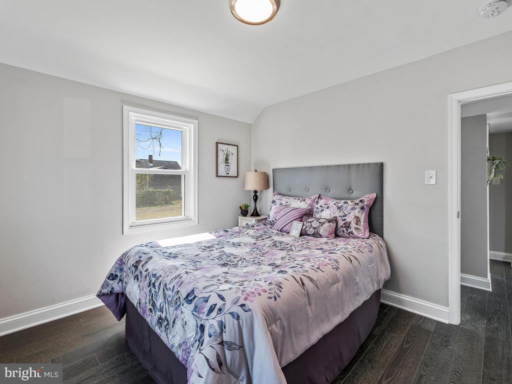 7718 Meath Road Dundalk, MD 21222 - Photo 12 of 27 a bedroom with a bed and wooden floor