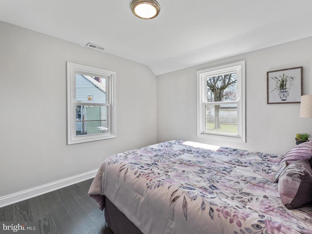 7718 Meath Road Dundalk, MD 21222 - Photo 13 of 27 a bedroom with a bed and a window