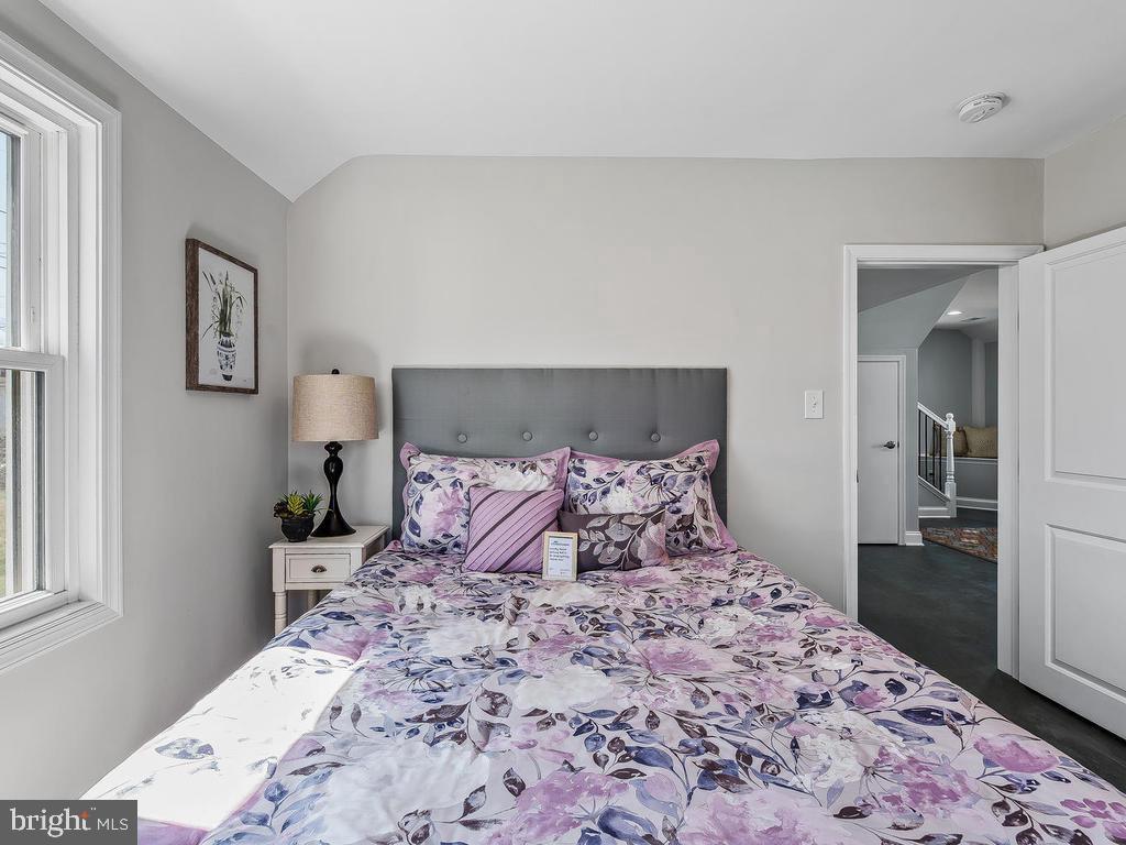 7718 Meath Road Dundalk, MD 21222 - Photo 14 of 27 a bedroom with a bed and a lamp