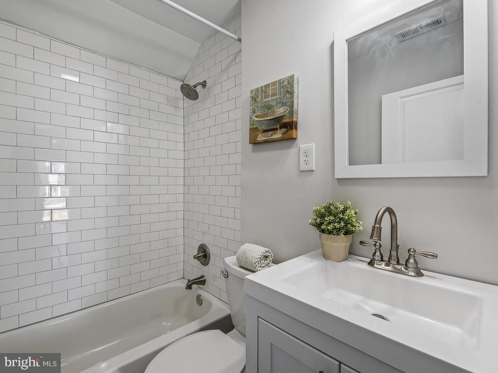 7718 Meath Road Dundalk, MD 21222 - Photo 16 of 27 a bathroom with a sink a toilet and shower