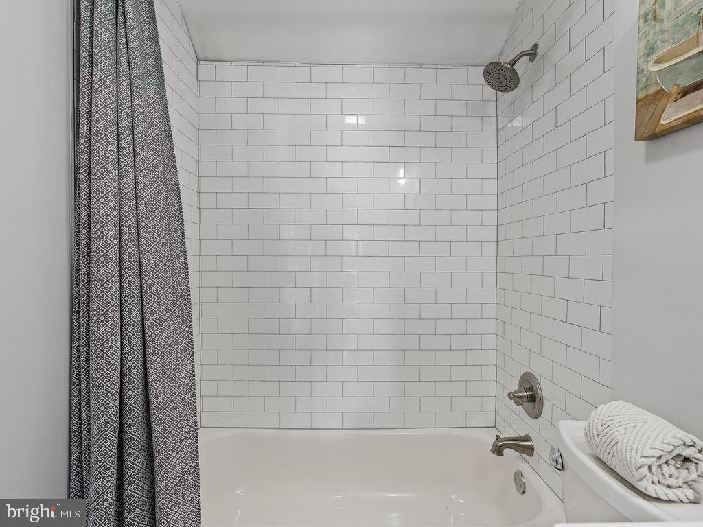 7718 Meath Road Dundalk, MD 21222 - Photo 17 of 27 a bathroom with a bathtub and shower