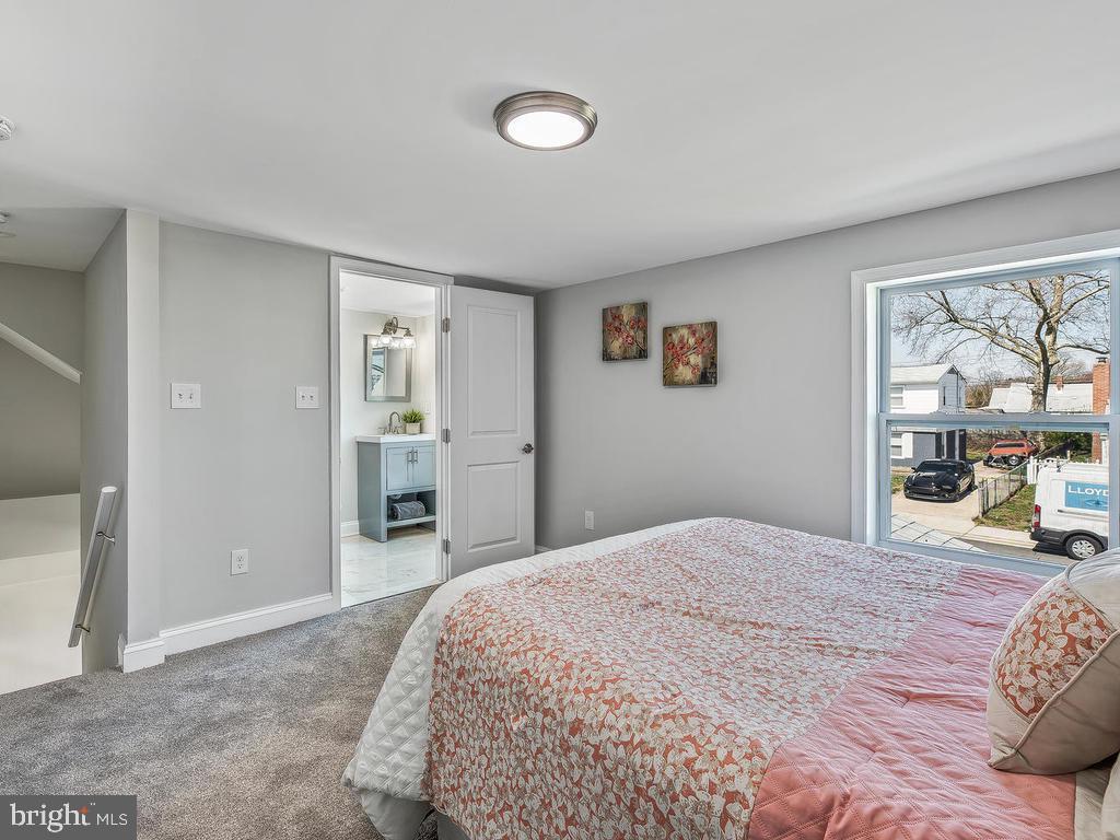 7718 Meath Road Dundalk, MD 21222 - Photo 22 of 27 a bedroom with a large bed and a window