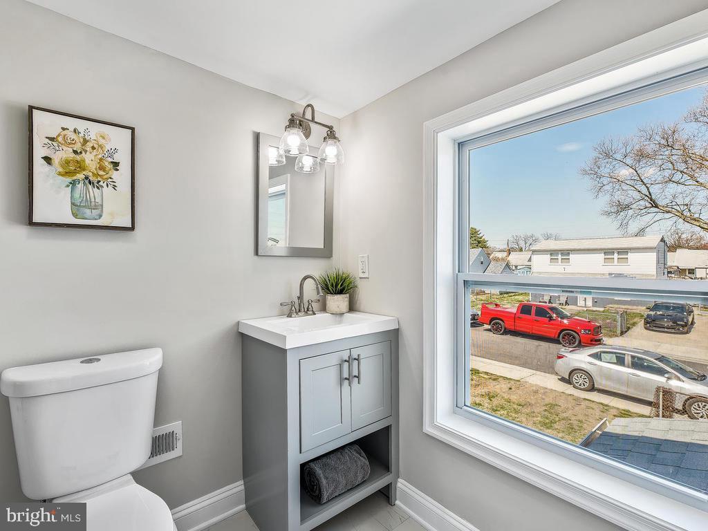 7718 Meath Road Dundalk, MD 21222 - Photo 23 of 27 a bathroom with a toilet sink and mirror