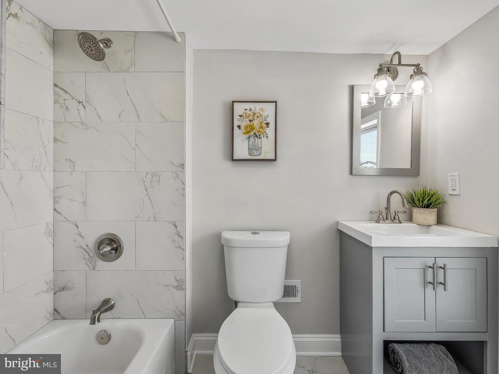 7718 Meath Road Dundalk, MD 21222 - Photo 24 of 27 a bathroom with a toilet sink and shower