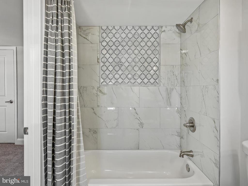 7718 Meath Road Dundalk, MD 21222 - Photo 25 of 27 a bathroom with a bathtub and shower