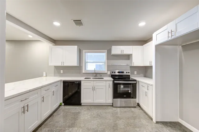 a kitchen with a stove top oven sink and refrigerator