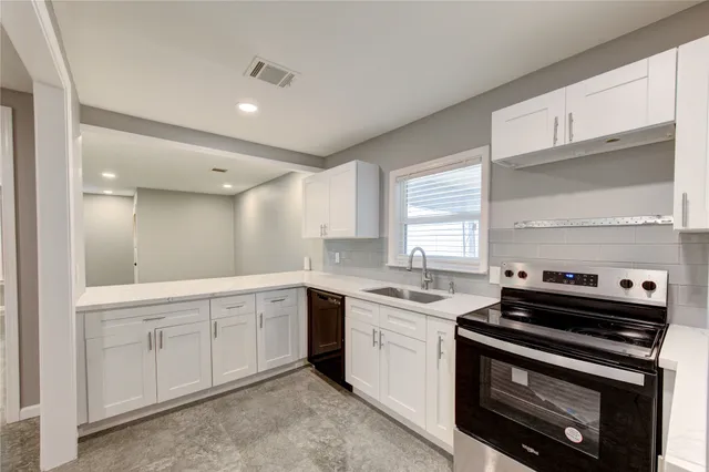 a kitchen with a stove and a sink