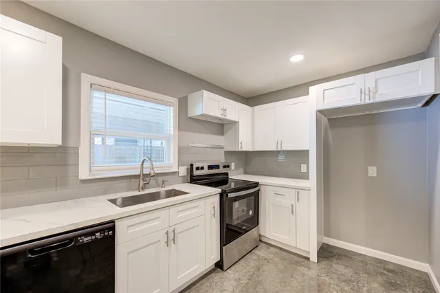 a kitchen with a sink stove and cabinets