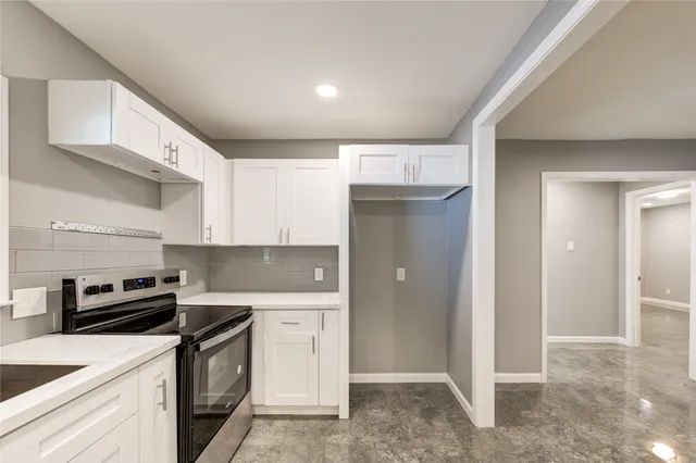 a kitchen with stainless steel appliances granite countertop a refrigerator and a stove