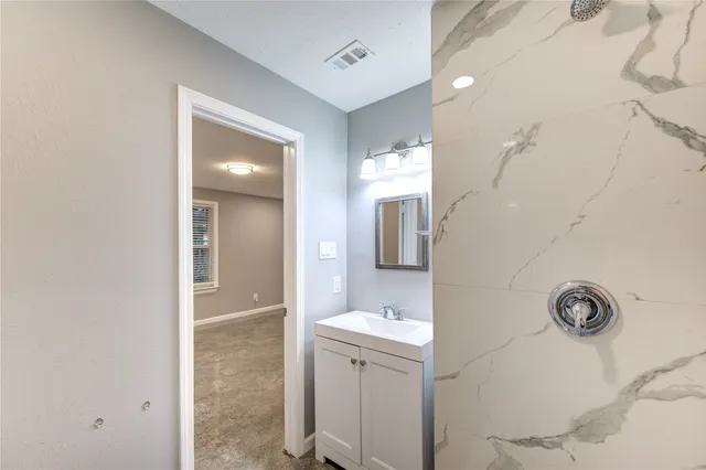 an empty room with closet and wooden door