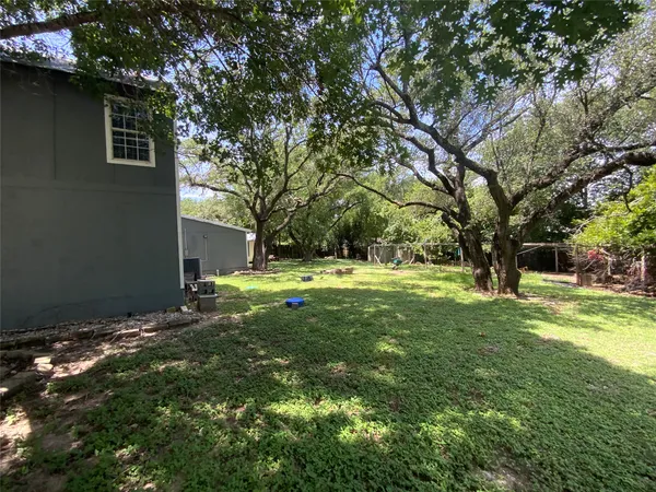a backyard of a house with table and chairs