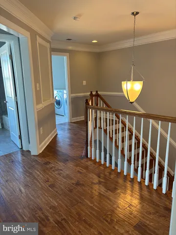 a view of a room with wooden floor and a window