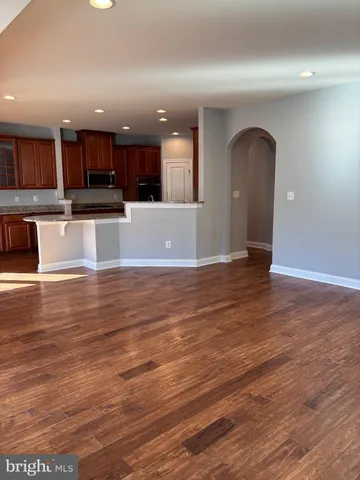 a view of kitchen with kitchen island stainless steel appliances refrigerator and stove