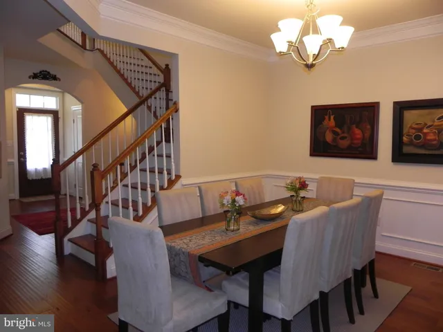 a view of a dining room with furniture wooden floor and chandelier