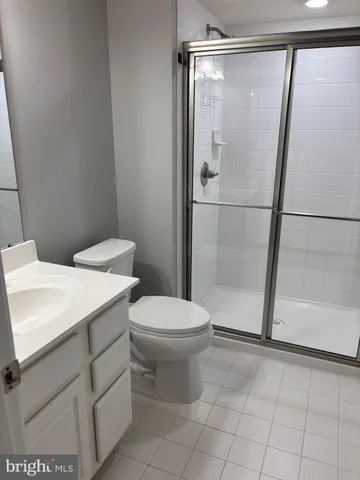 a white toilet sitting next to a bathroom sink
