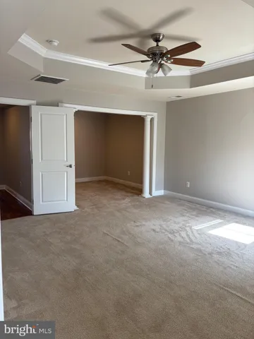 a view of a room with a ceiling fan