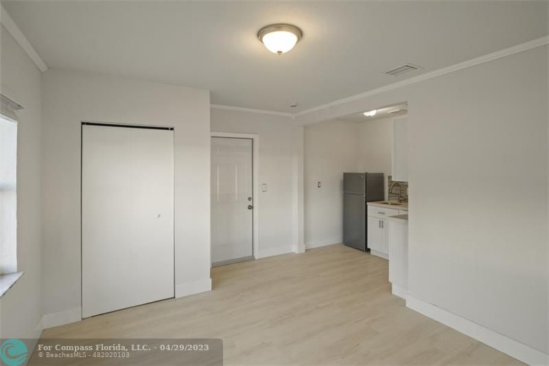 1219 Northwest 33rd Street, Unit B Miami, FL 33142 - Photo 2 of 6 a view of a kitchen with furniture and a refrigerator