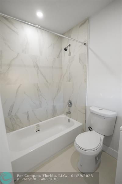 1219 Northwest 33rd Street, Unit B Miami, FL 33142 - Photo 5 of 6 a bathroom with a toilet and a bathtub