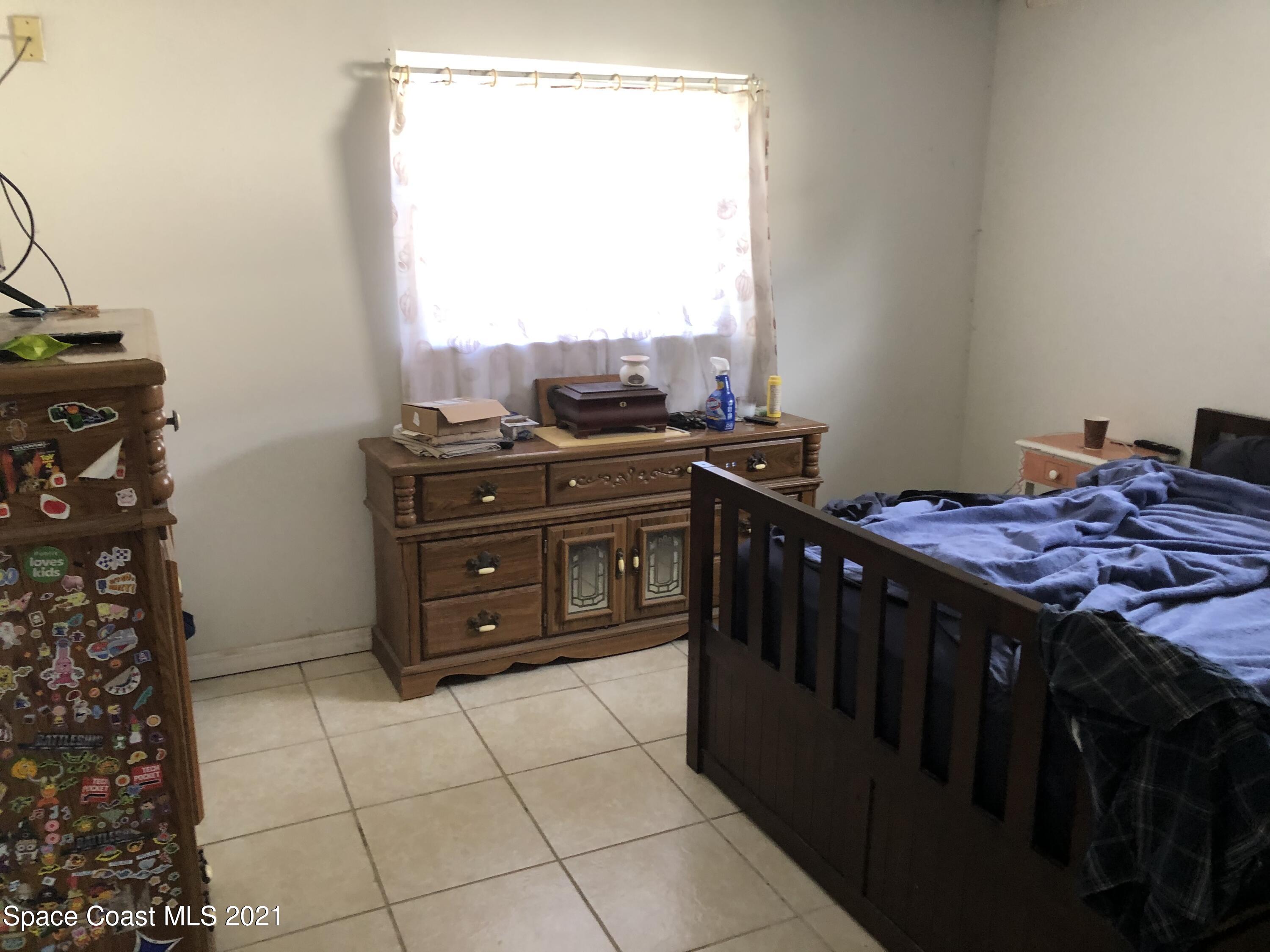 435 Count Street Melbourne, FL 32901 - Photo 3 of 7 a kitchen with a stove and a refrigerator