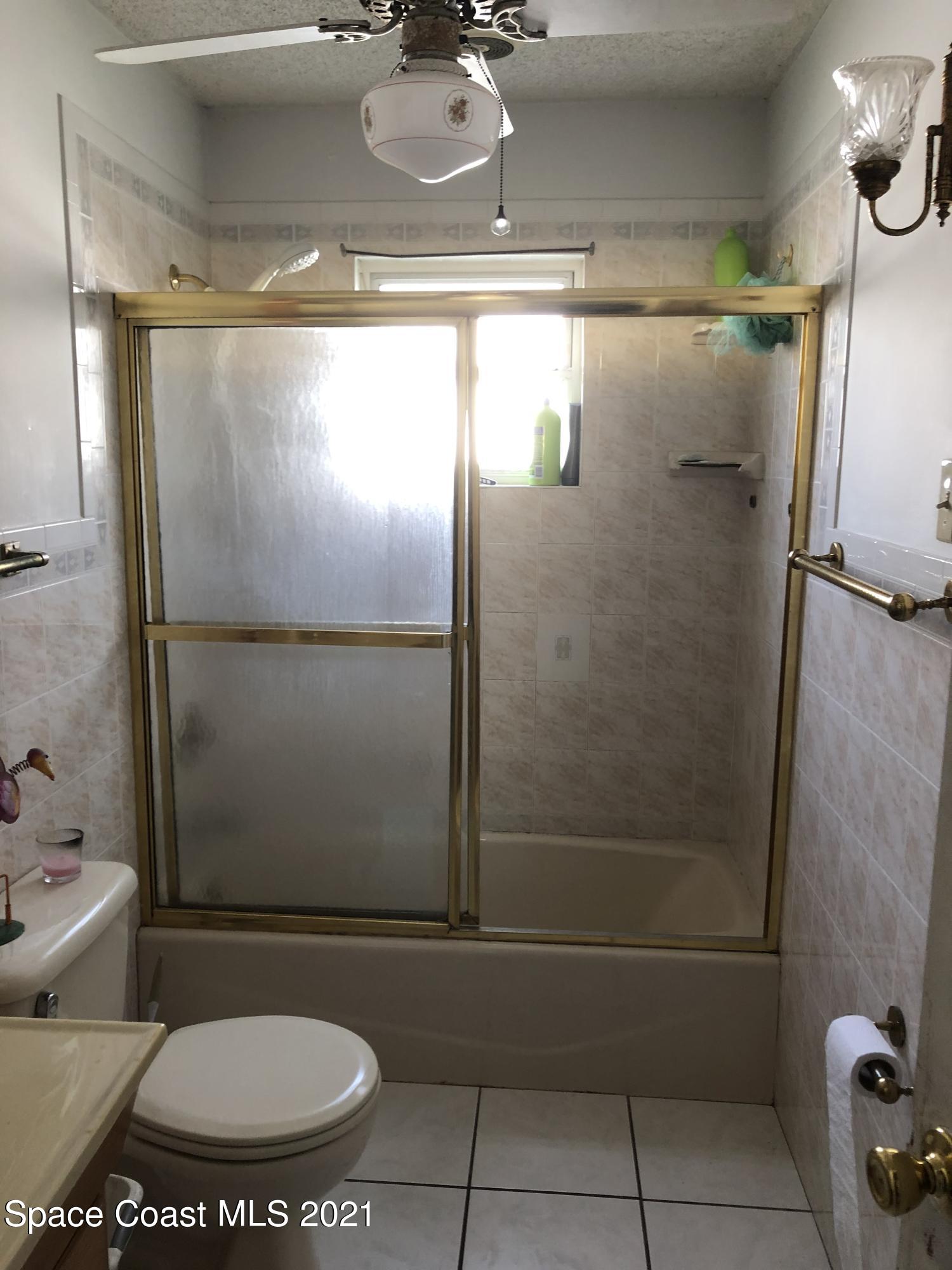 435 Count Street Melbourne, FL 32901 - Photo 4 of 7 a bathroom with a toilet and a shower