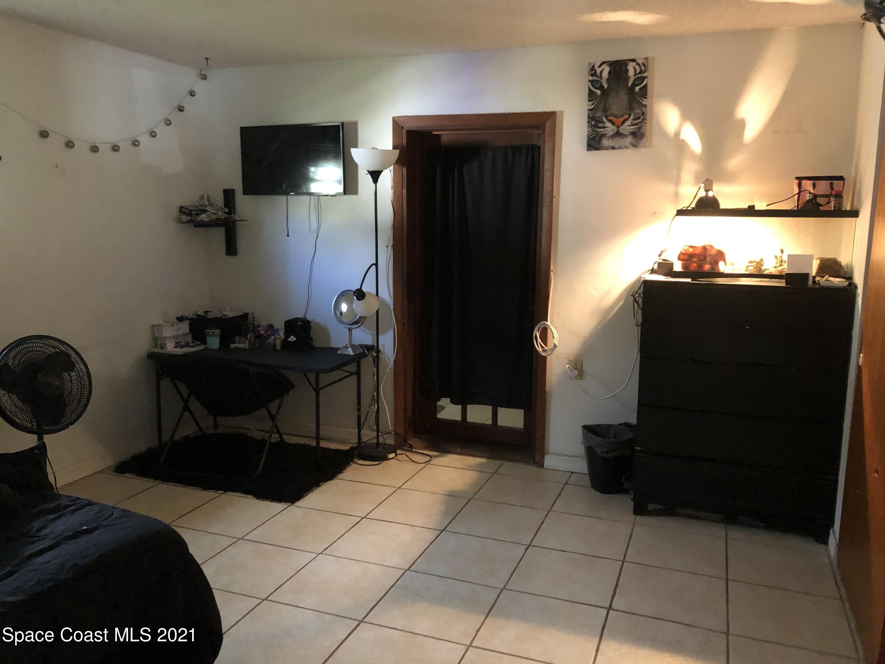 435 Count Street Melbourne, FL 32901 - Photo 5 of 7 a bedroom with a bed and cabinets