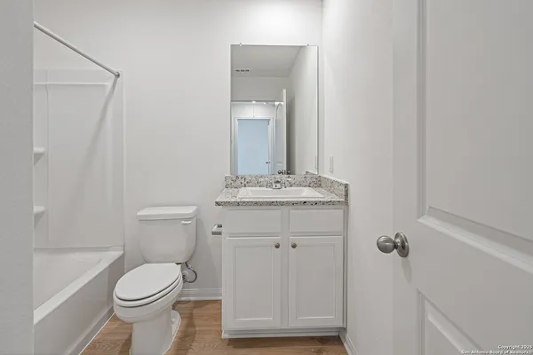 a bathroom with a toilet a sink and bathtub