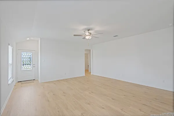 wooden floor in an empty room with a window