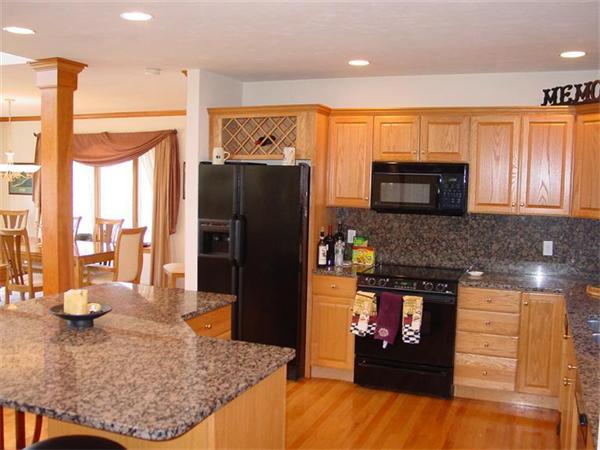 81 Edgewater Road Mashpee, MA 02649 - Photo 6 of 13 a kitchen with stainless steel appliances granite countertop a refrigerator a stove and a sink with wooden floor