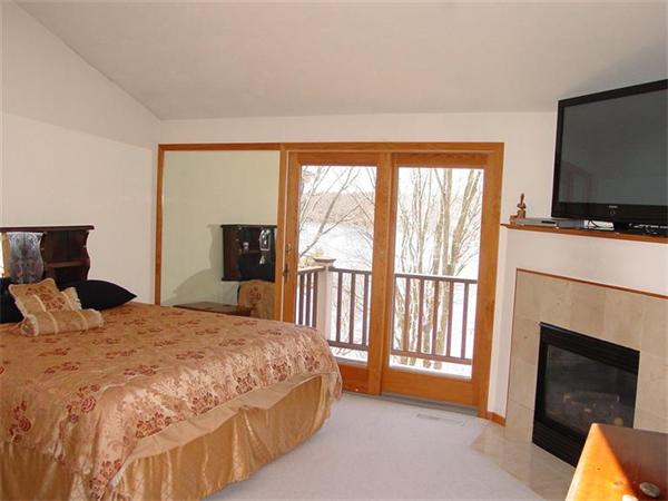 81 Edgewater Road Mashpee, MA 02649 - Photo 10 of 13 a bedroom with a bed and a flat screen tv