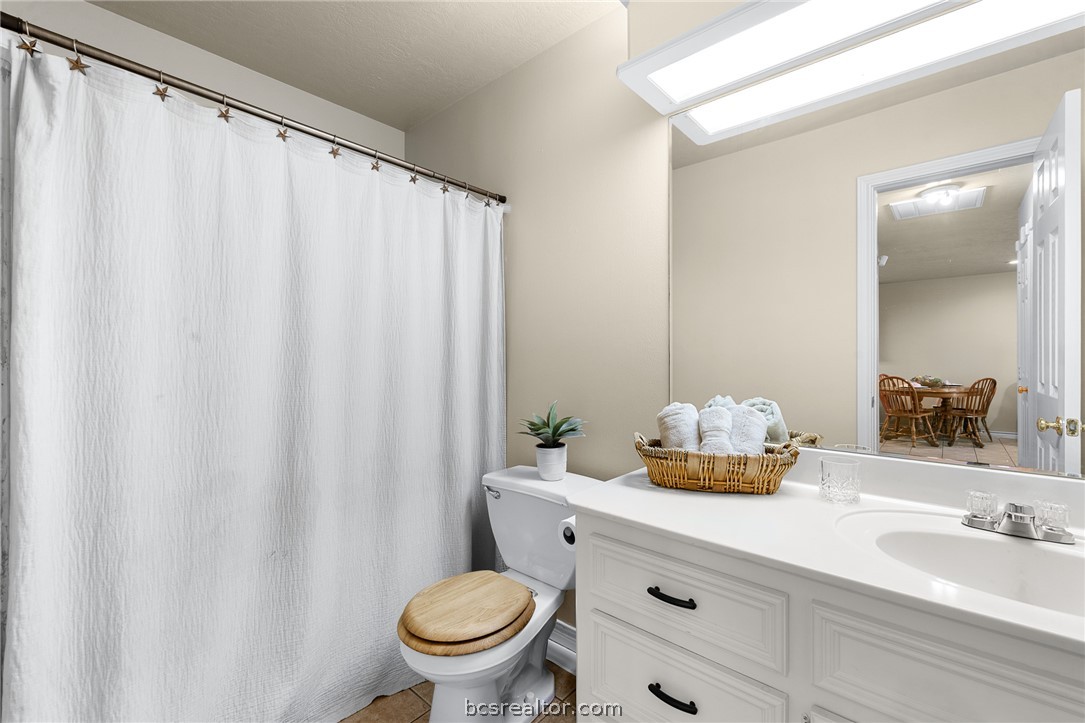 2287 North Earl Rudder Freeway Bryan, TX 77803 - Photo 6 of 32 a bathroom with a sink a toilet and shower curtain