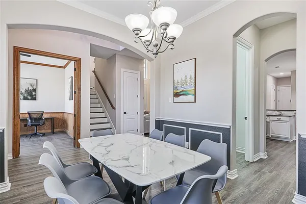 a view of a dining room with furniture wooden floor and chandelier