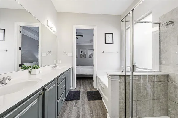 a bathroom with a double vanity sink a mirror and a shower
