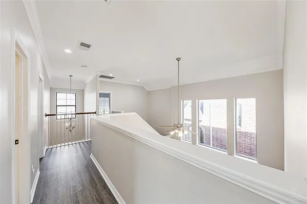 a kitchen with a refrigerator a sink and wooden floor