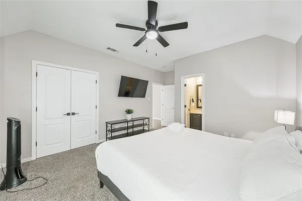 a bedroom with a bed and a flat screen tv