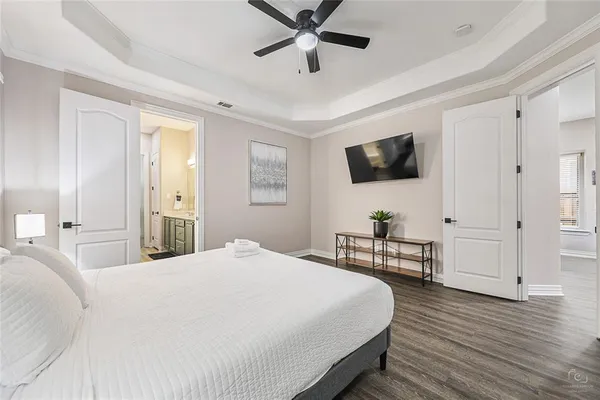 a bedroom with a bed and a flat screen tv