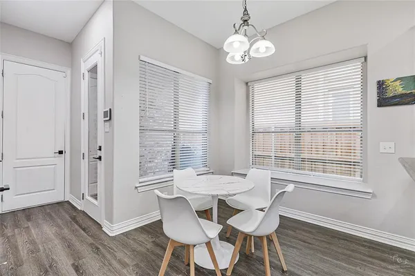 a view of a dining room with furniture windows and wooden floor