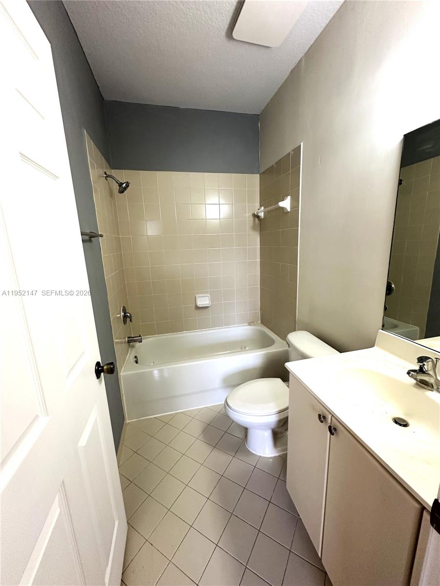 3550 Northeast 5th Street, Unit 202 Homestead, FL 33033 - Photo 18 of 23 a bathroom with a sink a toilet and shower