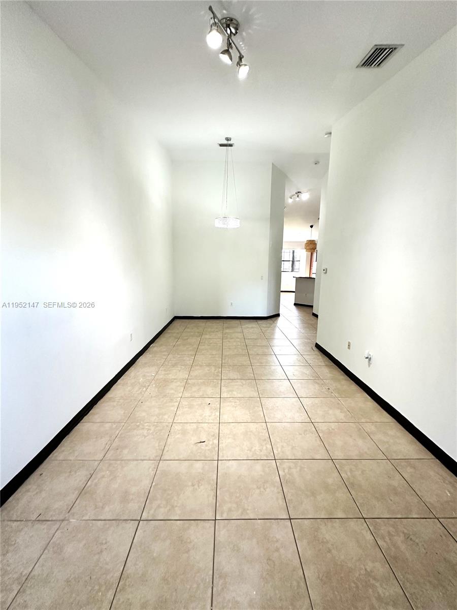 3550 Northeast 5th Street, Unit 202 Homestead, FL 33033 - Photo 5 of 23 a view of a hallway with a white walls