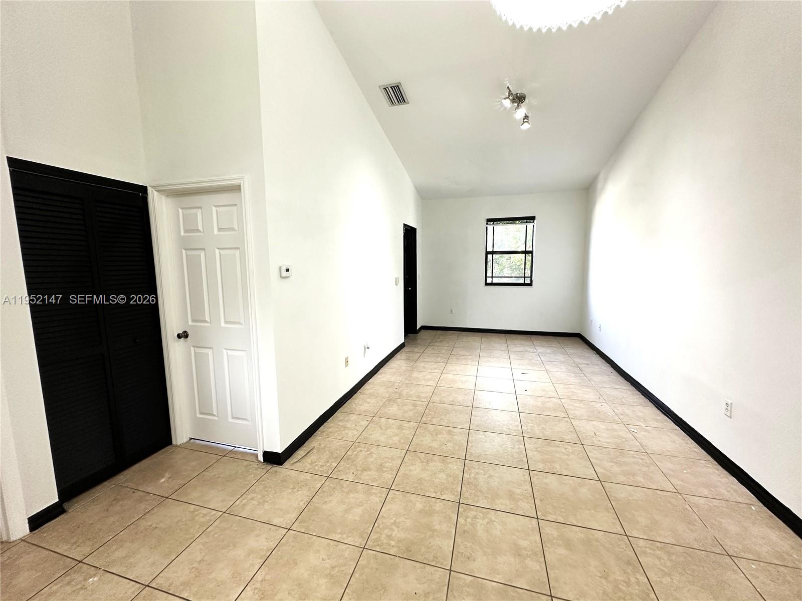 3550 Northeast 5th Street, Unit 202 Homestead, FL 33033 - Photo 8 of 23 a view of empty room with windows