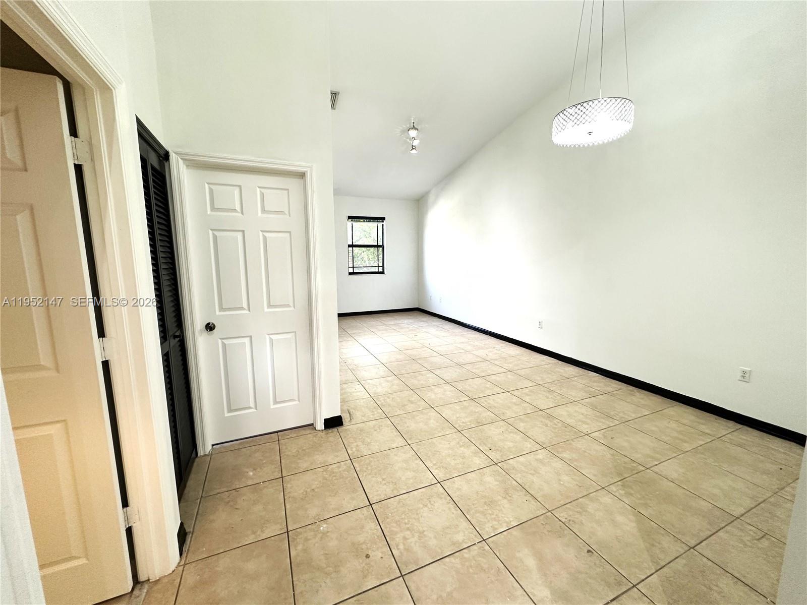 3550 Northeast 5th Street, Unit 202 Homestead, FL 33033 - Photo 9 of 23 a view of a livingroom with wooden floor and window