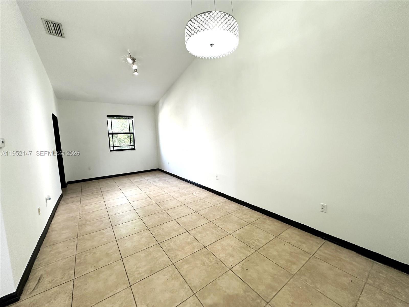 3550 Northeast 5th Street, Unit 202 Homestead, FL 33033 - Photo 10 of 23 an empty room with windows