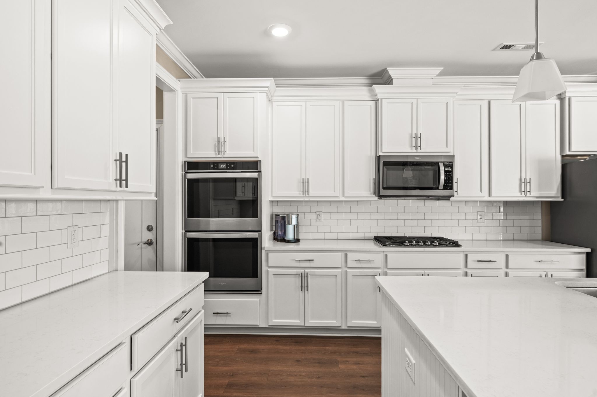 7345 Taylor Road Fairview, TN 37062 - Photo 12 of 65 a kitchen with white cabinets and stainless steel appliances