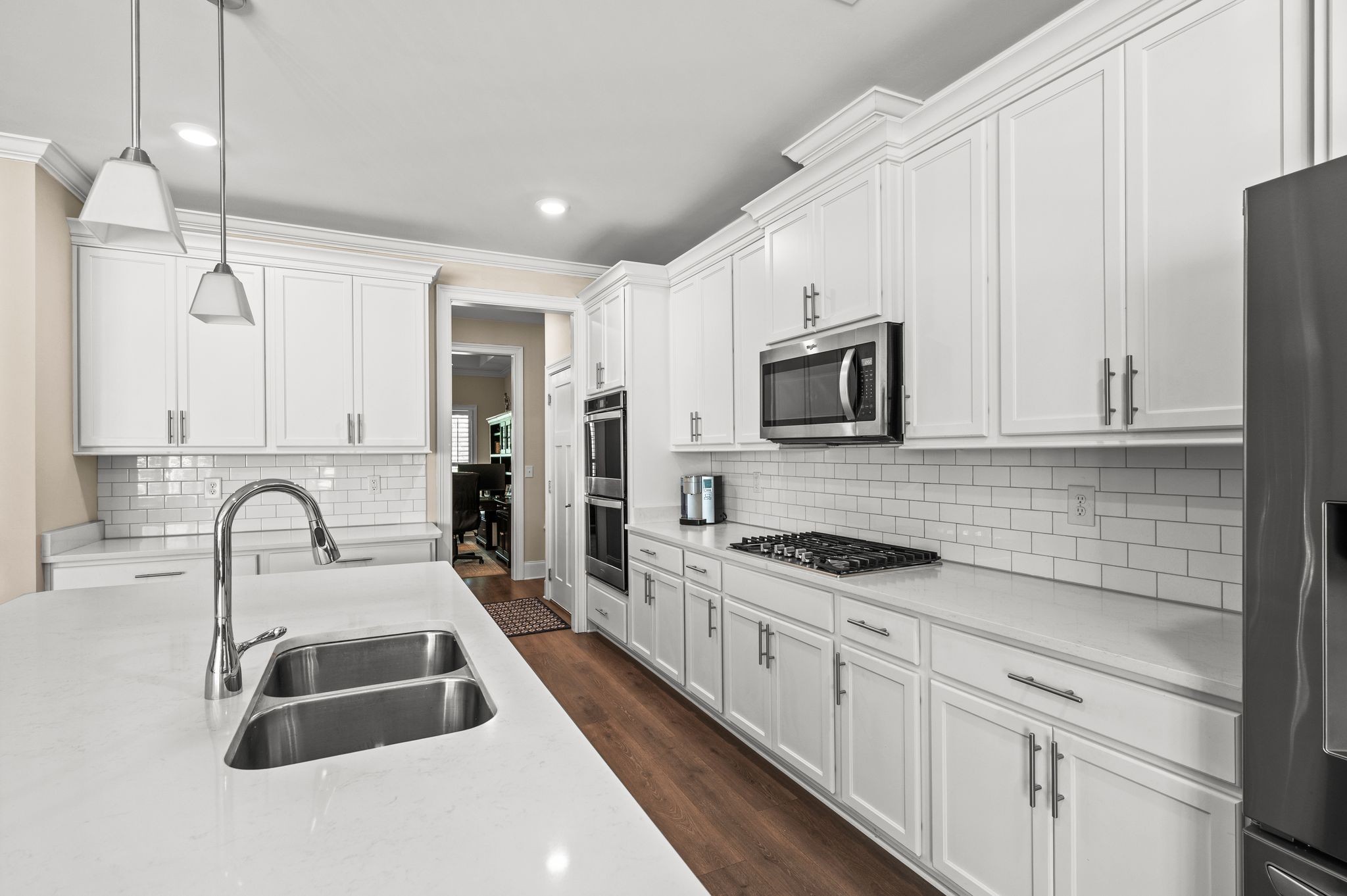7345 Taylor Road Fairview, TN 37062 - Photo 15 of 65 a kitchen with granite countertop a sink stainless steel appliances and white cabinets