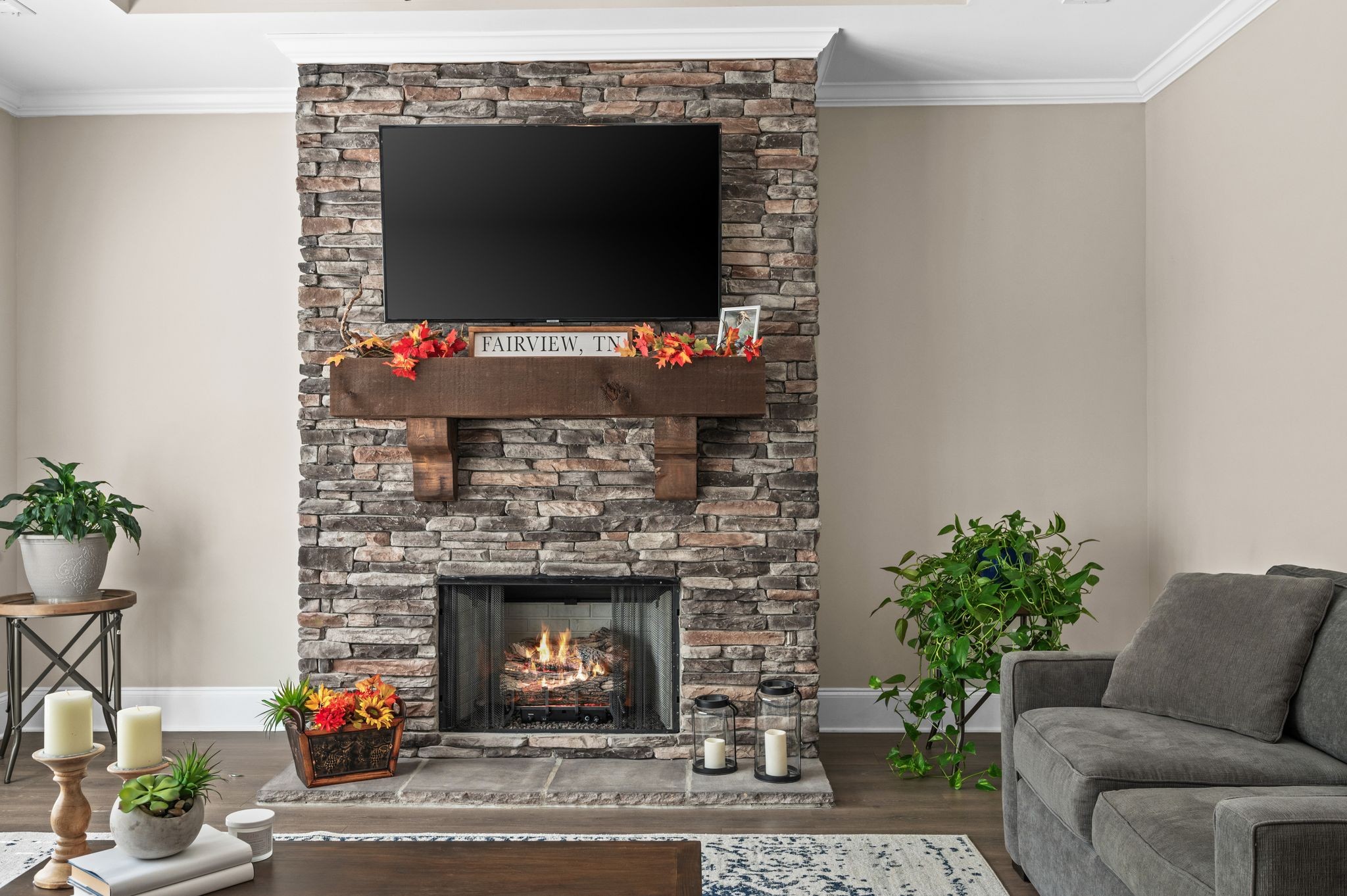 7345 Taylor Road Fairview, TN 37062 - Photo 23 of 65 a living room with furniture a flat screen tv and a fireplace