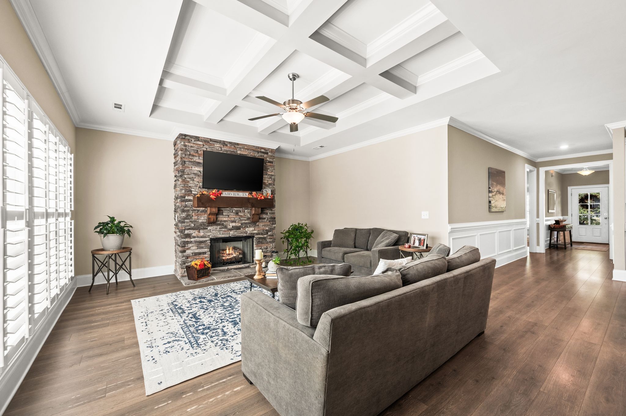 7345 Taylor Road Fairview, TN 37062 - Photo 24 of 65 a living room with furniture a fireplace and a flat screen tv
