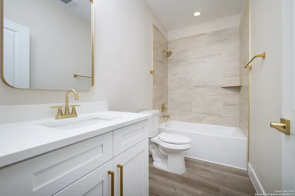 a bathroom with a sink a toilet and a mirror