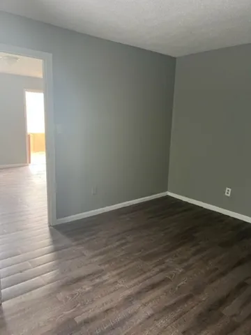 a view of an empty room and wooden floor