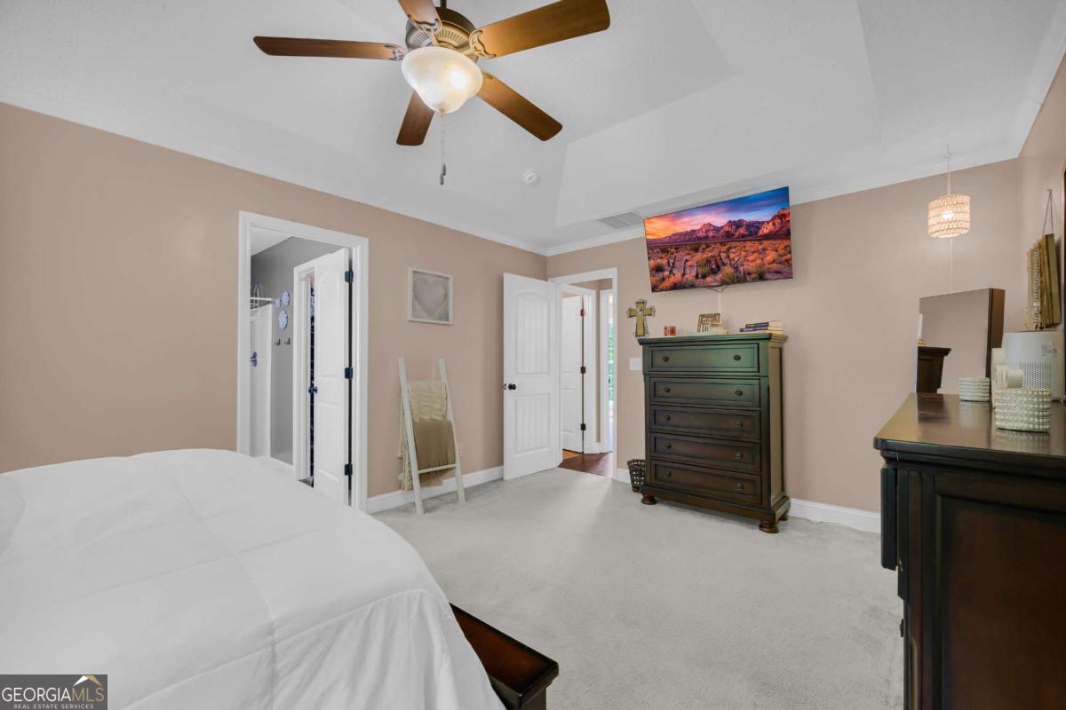 335 Elizabeth Court Colbert, GA 30628 - Photo 18 of 33 a bedroom with a bed and a flat screen tv